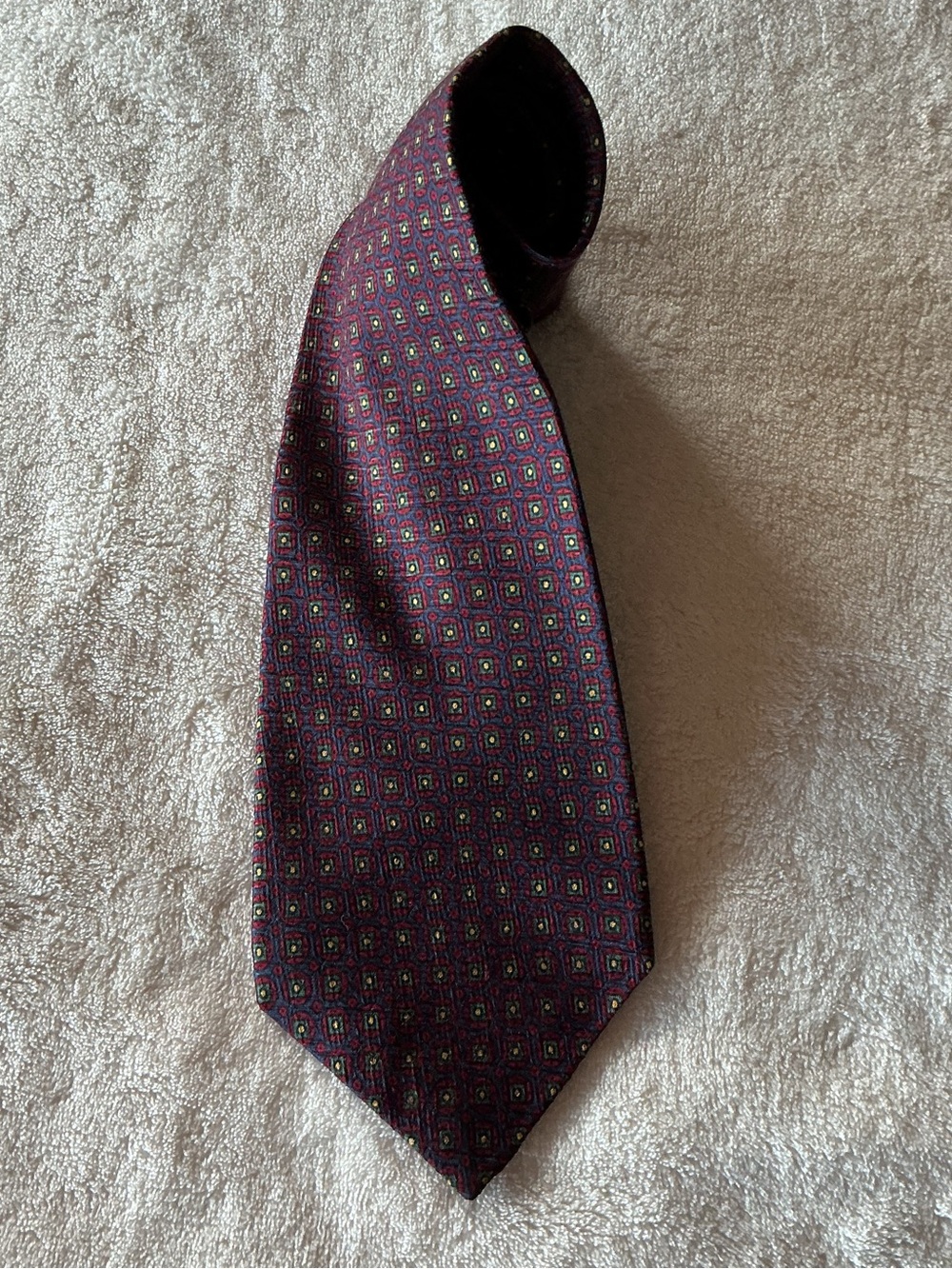 Polo Ralph Lauren 100% Silk tie small repeating medallions. Burgundy/navy/green.